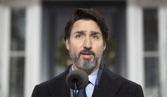 Canadian Prime Minister Justin Trudeau speaks at a bi-weekly news conference outside Rideau cottage on the COVID-19 pandemic in Ottawa, Ontario, Friday, Nov. 27, 2020. (Adrian Wyld/The Canadian Press via AP)