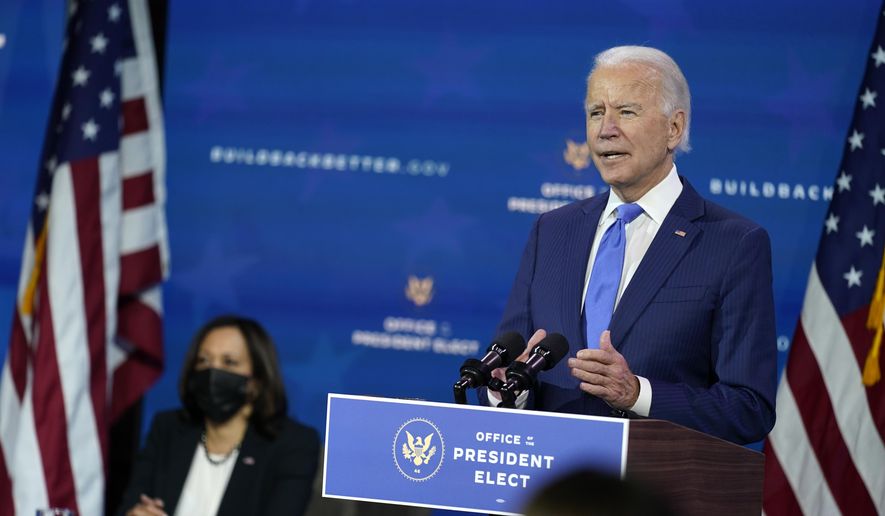 President-elect Joe Biden speaks as Vice President-elect Kamala Harris listens at left, during an event to introduce their nominees and appointees to economic policy posts at The Queen theater, Tuesday, Dec. 1, 2020, in Wilmington, Del. (AP Photo/Andrew Harnik)  **FILE**