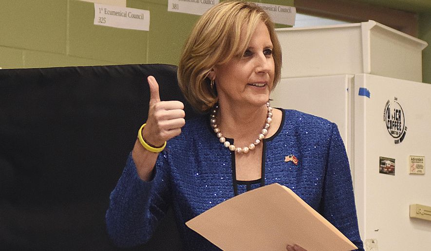 In this Nov. 6, 2018, file photo, Republican Congresswoman Claudia Tenney signals she successfully cast her ballot after voting at St. George&#39;s Church in New Hartford, N.Y. On Tuesday, Dec. 1, 2020, Chenango County informed a state judge it had discovered 55 early voting ballots that weren&#39;t canvassed by the local board of election, and therefore weren&#39;t included in the vote totals in the ultra-tight race between Tenney and U.S. Rep. Anthony Brindisi.  The most recent results — which don’t include those ballots — showed Tenney with a 12-vote lead over Brindisi. (AP Photo/Heather Ainsworth, File)