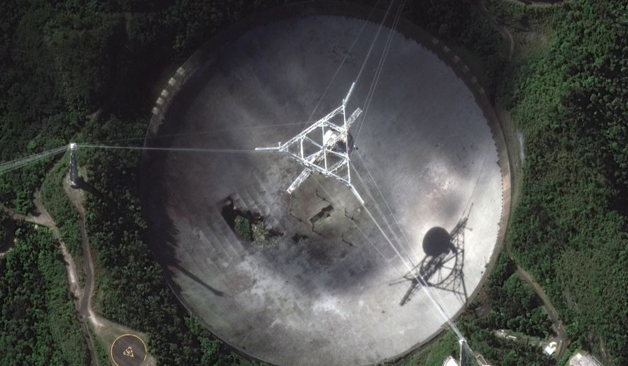 This satellite image provided by 2020 Maxar Technologies shows the damaged radio telescope at the Arecibo Observatory in Puerto Rico, Thursday, Nov. 17, 2020. The National Science Foundation announced Thursday, Nov. 17 that it will close the huge telescope in a blow to scientists worldwide who depend on it to search for planets, asteroids and extraterrestrial life, saying it’s too dangerous to keep operating the single-dish radio telescope because the entire structure could collapse. (Satellite image ©2020 Maxar Technologies via AP)