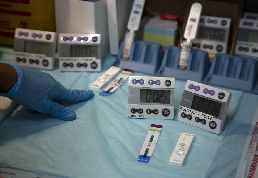 Laboratory technicians test a blood sample for HIV infection at the Reproductive Health and HIV Institute (RHI) in Johannesburg,Thursday, Nov. 26 2020. The successful trials of a new injectable drug that needs to be taken every eight weeks to prevent HIV infection is being lauded on World AIDS Day as a turning point for the fight against a global health threat that's been eclipsed by the coronavirus pandemic. (AP Photo/Denis Farrell)