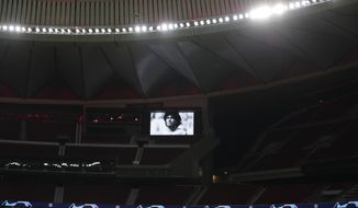 A picture of soccer legend Diego Armando Maradona is seen on the screen of the Wanda Metropolitano stadium in Madrid, Spain, prior to the Champions League group A soccer match between Atletico Madrid and Lokomotiv Moscow at Wednesday, Nov. 25, 2020. Maradona died Wednesday at the age of 60. (AP Photo/Manu Fernandez)