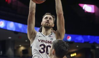 Virginia forward Jay Huff (30) dunks the ball in front of St. Francis forward Mark Flagg (42) during an NCAA college basketball game, Tuesday, Dec. 1, 2020 in Charlottesville, Va. (Andrew Shurleff/The Daily Progress via AP)