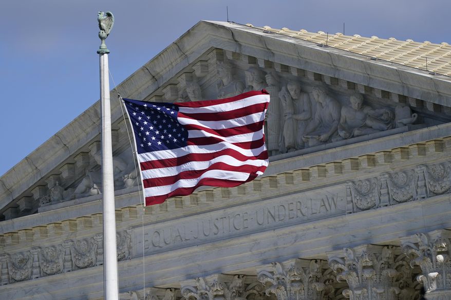 An American flag waves in front of the Supreme Court building, Monday, Nov. 2, 2020, on Capitol Hill in Washington. (AP Photo/Patrick Semansky)