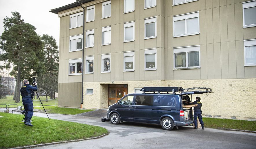 Police at the scene of an apartment where a woman is suspected of locking up her son, in Haninge, south of Stockholm, Tuesday, Dec. 1, 2020. Police in Stockholm are investigating a woman in her 70s for locking up her son for 28 years in an apartment south of the Swedish capital, investigators said Tuesday. Prosecutor Emma Olsson, who heads the preliminary investigation, said the woman who was arrested Monday, was held on suspicion of unlawful deprivation of liberty and grievous bodily harm. (Claudio Bresciani/TT via AP)