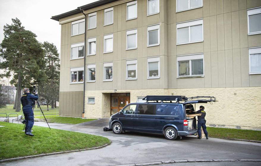 Police at the scene of an apartment where a woman is suspected of locking up her son, in Haninge, south of Stockholm, Tuesday, Dec. 1, 2020. Police in Stockholm are investigating a woman in her 70s for locking up her son for 28 years in an apartment south of the Swedish capital, investigators said Tuesday. Prosecutor Emma Olsson, who heads the preliminary investigation, said the woman who was arrested Monday, was held on suspicion of unlawful deprivation of liberty and grievous bodily harm. (Claudio Bresciani/TT via AP)
