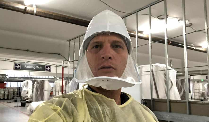 This Nov. 12, 2020 selfie photo provided by the Renown Regional Medical Center shows Dr. Jacob Keeperman, the Renown Transfer and Operations Center medical director who snapped the photo on the opening day of the Renown Regional Medical Center's alternative care site located in a parking garage. Keeperman's photo was being misrepresented online to support the false narrative that the coronavirus pandemic is a scam. (Jacob Keeperman/Renown Regional Medical Center via AP)