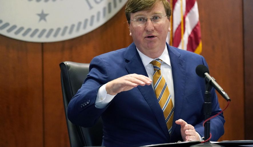 Mississippi Gov. Tate Reeves announces 13 additional counties that have qualified and met certain requirements to be placed under mask mandates with his "Safe Recovery" executive order that is in effect until December 11th during his COVID news briefing, Tuesday, Dec. 1, 2020, in Jackson, Miss. (AP Photo/Rogelio V. Solis)