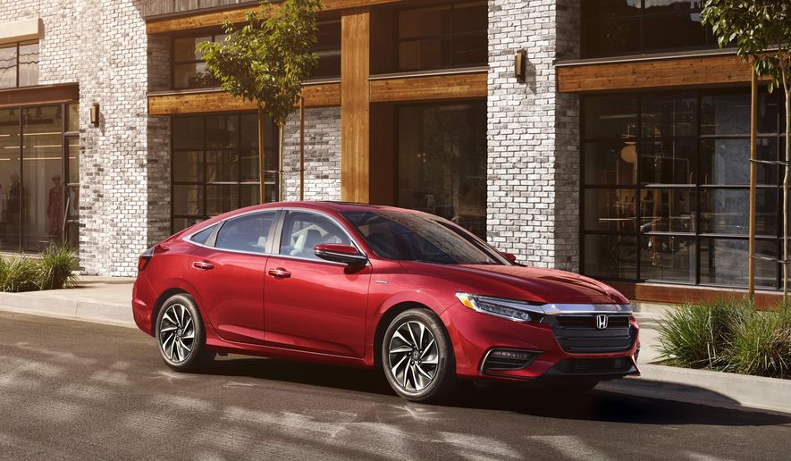 This Photo provided by Honda North America shows 2021 Honda Insight.   The EX model is only a little more expensive than the base LX and adds features such as Apple CarPlay and Android Auto functionality, a touchscreen infotainment system and blind-spot monitoring. According the Edmunds, payments on an Insight EX using their calculations will run just under $350 per month. (Honda North America via AP)