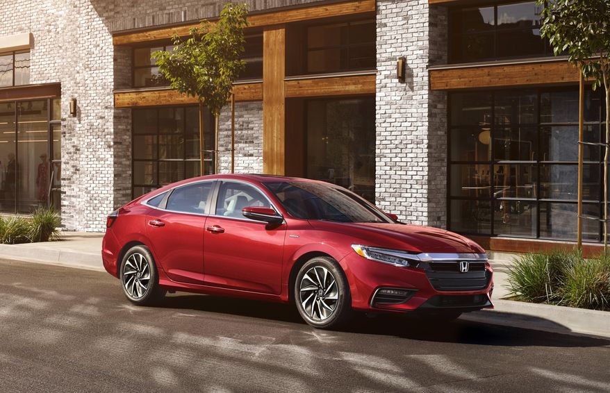 This Photo provided by Honda North America shows 2021 Honda Insight. The EX model is only a little more expensive than the base LX and adds features such as Apple CarPlay and Android Auto functionality, a touchscreen infotainment system and blind-spot monitoring. According the Edmunds, payments on an Insight EX using their calculations will run just under $350 per month. (Honda North America via AP)