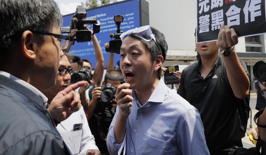 FILE - In this Aug. 12, 2019, file photo, pro-democracy lawmaker Ted Hui, center, argues with pro-Beijing lawmaker Junius Ho, left, during a demonstration in Hong Kong. Hui who is currently visiting Denmark urged European nations on Wednesday to allow protesters in Hong Kong &amp;quot;a safe haven from the terror” of China&#39;s Communist Party. (AP Photo/Kin Cheung, File)