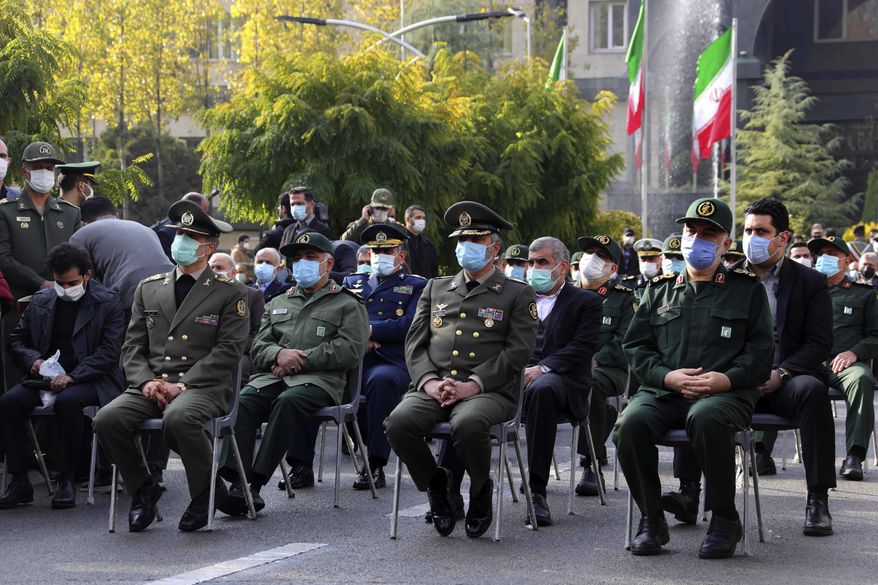 In this photo released by the official website of the Iranian Defense Ministry, military military commanders attend a funeral ceremony of Mohsen Fakhrizadeh, a scientist who was killed on Friday, in a funeral ceremony in Tehran, Iran, Monday, Nov. 30, 2020. Iran held the funeral Monday for the slain scientist who founded its military nuclear program two decades ago, with the Islamic Republic&#39;s defense minister vowing to continue the man&#39;s work &amp;quot;with more speed and more power.&amp;quot; (Iranian Defense Ministry via AP)
