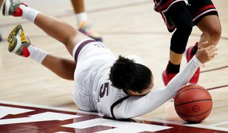 Texas A&amp;amp;M guard Jordan Nixon (5) dives for a loose ball against Lamar during the second half of an NCAA college basketball game Wednesday, Nov. 25, 2020, in College Station, Texas. (AP Photo/Sam Craft)