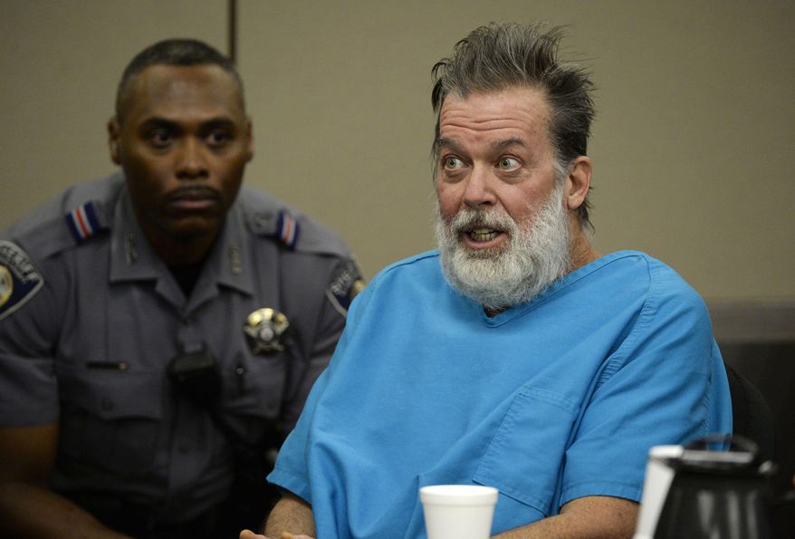 FILE - In this Dec. 9, 2015, file photo, Robert Dear talks to Judge Gilbert Martinez during a court appearance in Colorado Springs, Colo. Federal prosecutors said Wednesday, Dec. 2, 2020, they would not seek the death penalty against Dear, accused of killing three people and injuring nine others at a Planned Parenthood clinic in Colorado in 2015. Prosecutors have repeatedly deemed incompetent to stand trial. Dear, however, has insisted he is competent. (Andy Cross/The Denver Post via AP, Pool, File)
