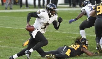 Baltimore Ravens quarterback Robert Griffin III (3) scrambles past Pittsburgh Steelers outside linebacker Bud Dupree (48) during the first half of an NFL football game, Wednesday, Dec. 2, 2020, in Pittsburgh. (AP Photo/Don Wright)