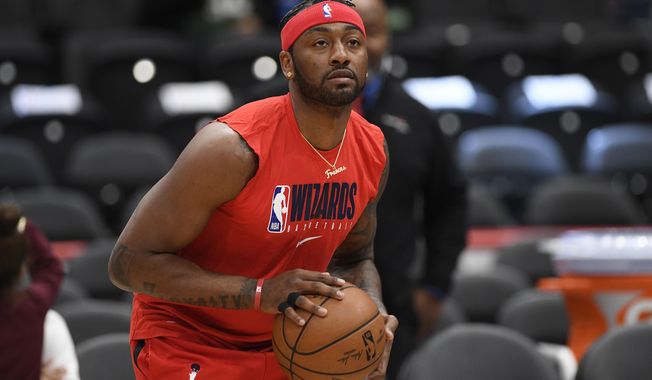 FILE - In this Monday, Feb. 24, 2020 file photo, Washington Wizards guard John Wall works out prior to an NBA basketball game against the Milwaukee Bucks in Washington. The Houston Rockets have traded Russell Westbrook to the Washington Wizards for John Wall and a future lottery-protected. first-round pick. Both teams announced the trade Wednesday night, Dec. 2., 2020. (AP Photo/Nick Wass, File)