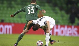 Krasnodar&#39;s Marcus Berg, left, and Rennes&#39; Damien Da Silva challenge for the ball during the UEFA Champions League, Group E, soccer match between Krasnodar and Rennes at the Krasnodar Stadium in Krasnodar, Russia, Wednesday, Dec. 2, 2020. (AP Photo)
