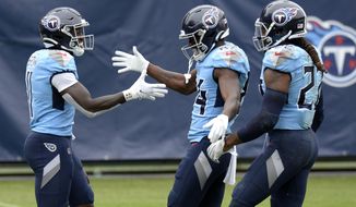 FILE - In this Oct. 25, 2020, file photo, Tennessee Titans wide receiver A.J. Brown (11) is congratulated by Corey Davis (84) and Derrick Henry (22) after Brown scored a touchdown on a 73-yard pass reception in the second half of an NFL football game against the Pittsburgh Steelers in Nashville, Tenn. Tennessee has been looking for years for top wide receivers, and the Titans now have two in A.J. Brown and Corey Davis who make big plays with key catches while also blocking for Henry whenever the NFL&#39;s leading rusher has the ball.  (AP Photo/Mark Zaleski, File)