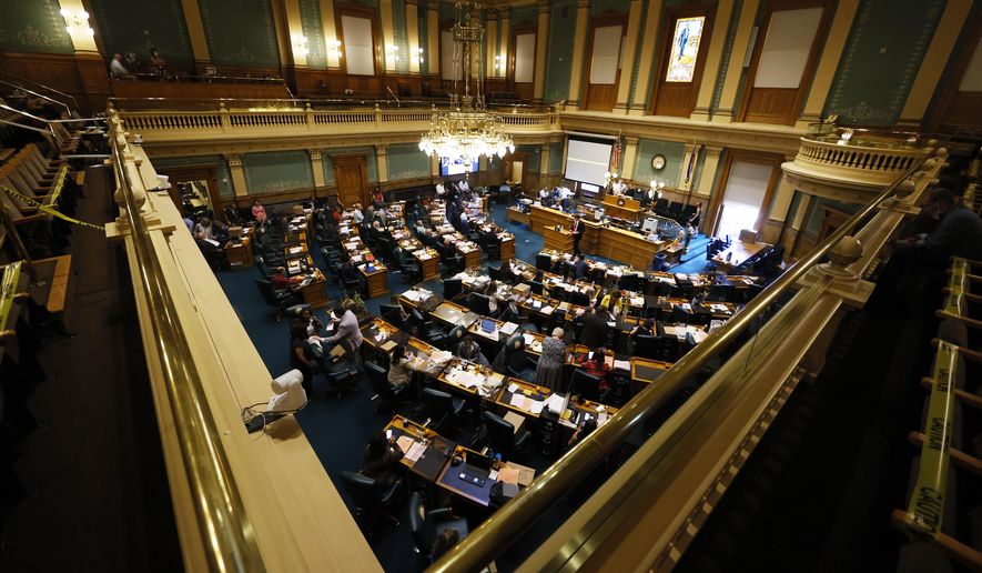FILE - In this June 15, 2020, file photo, members of the Colorado House of Representatives toil as lawmakers try to wrap up the 2020 session in the State Capitol in Denver. In an effort to keep Colorado residents fed and employed this winter, Colorado's Legislature concluded a special session Wednesday, Dec. 2, by passing bills offering assistance to restaurants and food pantries struggling to keep their doors open during the coronavirus pandemic. This week's session, called by Gov. Jared Polis, also passed bills creating and expanding several grant programs to improve internet access for students, assist childcare providers and aid individuals struggling to pay their utility and housing bills. (AP Photo/David Zalubowski, File)