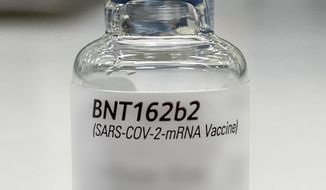 In this undated photo released by Pfizer on Tuesday, Dec. 1, 2020, a vial of the COVID-19 candidate vaccine developed by BioNTech and Pfizer is shown displayed at the headquarters in Puurs, Belgium.  The vaccine is awaiting approval to use against the coronavirus.  (Pfizer via AP)