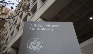 In this Nov. 30, 2017, file photo, the J. Edgar Hoover FBI Building is seen in Washington. (AP Photo/Carolyn Kaster, File)