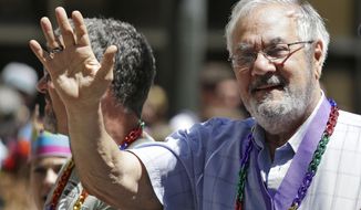FILE - In this June 29, 2014, file photo, former Massachusetts congressman Barney Frank, right, waves while riding with his husband James Ready, left, during the 44th annual San Francisco Gay Pride parade in San Francisco. Frank and Ready filed a lawsuit Wednesday, Dec. 2, 2020, against a construction contractor who they said abandoned the building of their home in Maine in May after only completing part of the agreed upon work. (AP Photo/Eric Risberg, File)