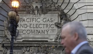 FILE - In this Dec. 16, 2019, file photo, is a man walking past a Pacific Gas and Electric sign on a PG&amp;amp;E building in San Francisco. PG&amp;amp;E&#39;s household customers will be hit with an average rate increase of 8% to help the once-bankrupt utility pay for improvements designed to reduce the risks that its outdated equipment will ignite deadly wildfires in its Northern California service territory. The higher prices, effective March 1, are expected to boost the bills of PG&amp;amp;E&#39;s residential customers by an average of $13.44 to per month.  (AP Photo/Jeff Chiu, File)
