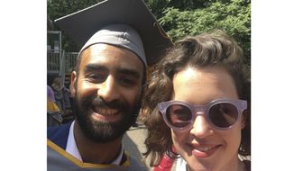 In this 2018 photo taken in London shows Karim Ennarah and his now-wife Jess Kelly posing for a photograph after they graduated from the School of Oriental and African Studies.  The acting director of a prominent Egyptian rights group says its three staffers, Ennara, Executive director Gasser Abdel-Razek and Mohammed Bashir, who were arrested last month have been freed on Thursday, Dec. 3, 2020.  They were arrested in November after EIPR hosted foreign diplomats to discuss the human rights situation in Egypt. They were charged with terrorism and spreading false information. (Courtesy of Jess Kelly via AP)