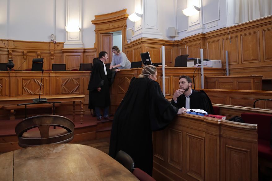 French lawyer Thibaut Kursawa, right, defending retired French surgeon Joel Le Scouarnec attends the opening day of the trial in the courthouse of Saintes, western France, Friday, March 13, 2020. A retired French surgeon accused of raping or sexually abusing more than 300 girls – often on the operating table - goes on trial, in a case that took decades to come to light and may be France's worst single sexual abuse case to date. (AP Photo/Francois Mori)