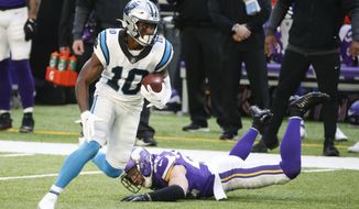 Carolina Panthers wide receiver Curtis Samuel (10) runs from Minnesota Vikings safety Harrison Smith, right, after catching a pass during the second half of an NFL football game, Sunday, Nov. 29, 2020, in Minneapolis. (AP Photo/Bruce Kluckhohn)