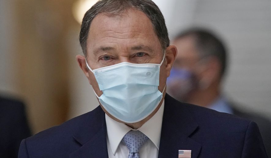 FILE - In this Nov. 9, 2020, file photo, Utah Gov. Gary Herbert walks through the Capitol rotunda to a COVID-19 briefing in Salt Lake City. Gov. Herbert says Utah plans to prioritize front-line health care workers after it receives its first round of a coronavirus vaccine doses. They could arrive as early as mid-December. (AP Photo/Rick Bowmer, File)