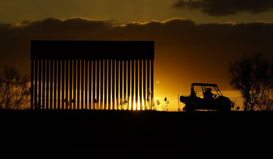 Authorities pass a border wall construction site, in Mission, Texas, Monday, Nov. 16, 2020. President-elect Joe Biden will face immediate pressure to fulfill his pledge to stop border wall construction. But he will confront a series of tough choices left behind by President Donald Trump, who&#39;s ramped up construction in his final weeks. (AP Photo/Eric Gay)