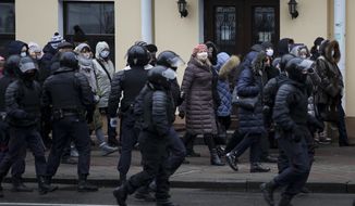 Riot police block Belarusian pensioners wearing face masks to protect against coronavirus during an opposition rally to protest the official presidential election results in Minsk, Belarus, Monday, Nov. 30, 2020. Hundreds of retirees rallied in the Belarusian capital on Monday against the country&#39;s authoritarian leader, as security forces moved to break up the traditional weekly march. The crowd of pensioners in Minsk that demanded President Alexander Lukashenko to resign ran into police cordons along the route of the march and divided into smaller groups that went into different directions. (AP Photo)