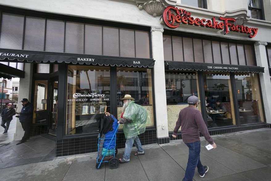 FILE - This Feb. 3, 2017 file photo shows The Cheesecake Factory restaurant in Old Pasadena, Calif.  The U.S. Securities and Exchange Commission said Friday, Dec. 4, 2020, that The Cheesecake Factory settled charges that it misled investors on the impact the pandemic was having on its business. The Cheesecake Factory said in March and April government filings that it was “operating sustainably” during the pandemic. (AP Photo/Damian Dovarganes)
