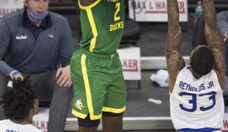 Oregon&#39;s Eugene Omoruyi scores against Seton Hall&#39;s Ike Obiagu, left, and Shavar Reynolds Jr. during the first half of an NCAA college basketball game in Omaha, Neb., Friday, Dec. 4, 2020. (AP Photo/Kayla Wolf)