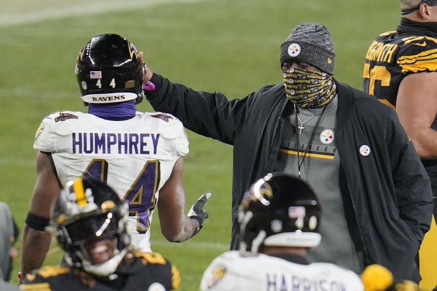 Pittsburgh Steelers coach Mike Tomlin, right, greets Baltimore Ravens cornerback Marlon Humphrey (44) after an NFL football game Wednesday, Dec 2, 2020, in Pittsburgh. The Steelers won 19-14. (AP Photo/Gene J. Puskar)