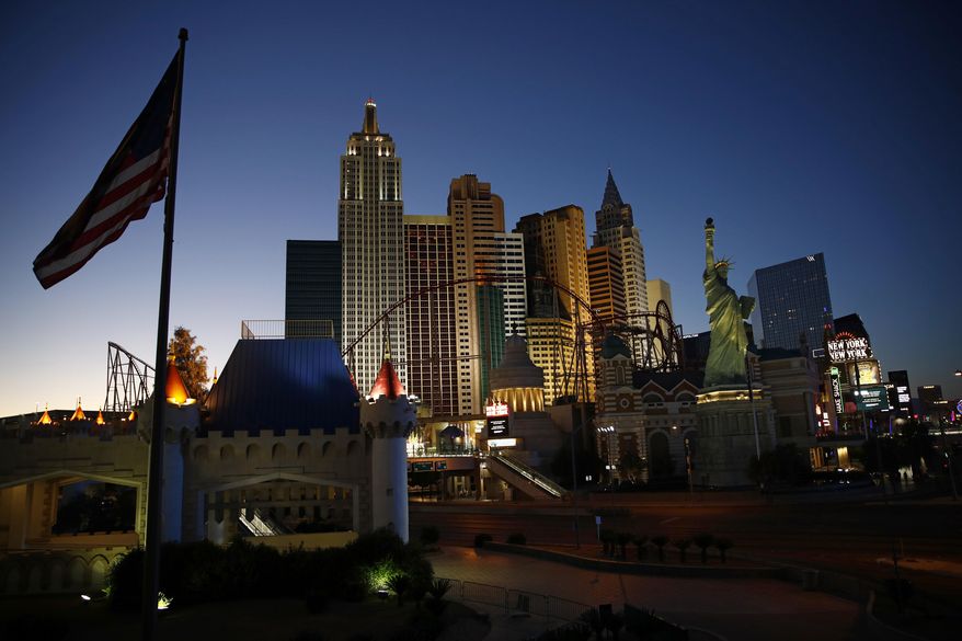 FILE - In this April 28, 2020, file photo, the sun sets behind casinos and hotels along the Las Vegas Strip in Las Vegas. Two prominent Las Vegas communications executives are suing more than 20 online travel companies for back taxes they say should have been paid to Nevada based on hotel room rates.(AP Photo/John Locher, File)