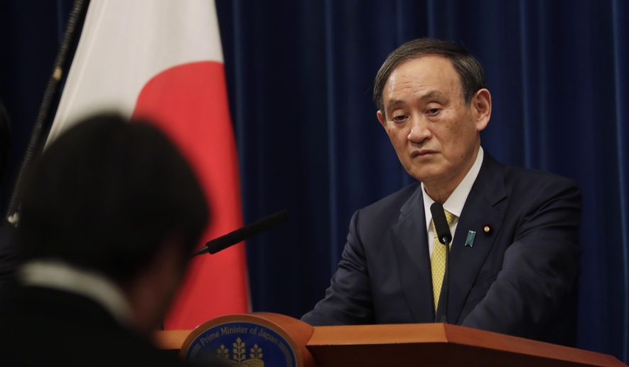 Japanese Prime Minister Yoshihide Suga speaks during a news conference in Tokyo on Friday, Dec. 4, 2020. Suga announced a 2 trillion green fund to promote innovation and technology to achieve his pledge to achieve a carbon free society by 2050.(AP Photo/Hiro Komae, Pool)