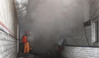 In this photo released by Xinhua News Agency, rescue workers gauge the density of carbon monoxide in the smog at the entrance of the coal mine in Yongchuan District of Chongqing, southwestern China, Friday, Dec. 4, 2020. China&#39;s state TV says more than a dozen coal miners have been killed by high levels of carbon monoxide in the country&#39;s southwest. (Huang Wei/Xinhua via AP)
