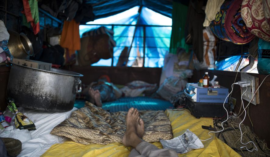 Protesting farmers rest in their tractor parked on a highway as they participate in farmers protest against new farming laws they say will result in exploitation by corporations, eventually rendering them landless, at the Delhi-Haryana state border, India, Tuesday, Dec. 1, 2020. The busy, nonstop, arterial highways that connect most northern Indian towns to this city of 29 million people, now beat to the rhythm of never-heard-before cries of “Inquilab Zindabad” (“Long live the revolution”). Tens and thousands of farmers, with colorful distinctive turbans and long, flowing beards, have descended upon its borders where they commandeer wide swathes of roads. (AP Photo/Altaf Qadri)