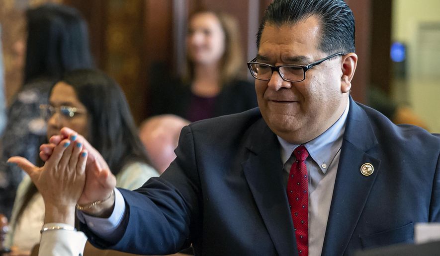 FILE - In this June 2, 2019 file photo Illinois State Sen. Martin Sandoval, D-Chicago, at the Illinois State Capitol, in Springfield, Ill.  Sandoval, who pleaded guilty in January to political corruption, has died from COVID-19 complications, his attorney said Saturday, Dec. 5, 2020. Sandoval, who was cooperating with federal authorities, was in the hospital before his death, said attorney Dylan Smith, who added that he spoke with the former lawmaker’s family. (Justin L. Fowler/The State Journal-Register via AP)
