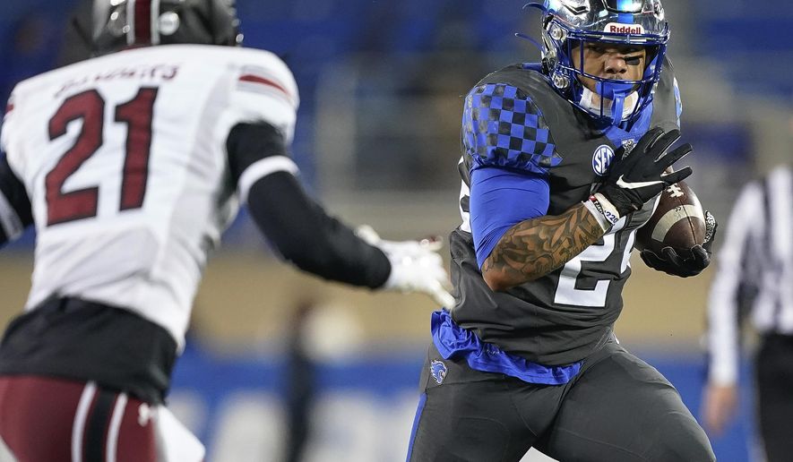 Kentucky running back Chris Rodriguez Jr. carries the ball as South Carolina's Shilo Sanders defends during the first half of an NCAA college football game Saturday, Dec. 5, 2020, in Lexington, Ky. (AP Photo/Bryan Woolston)