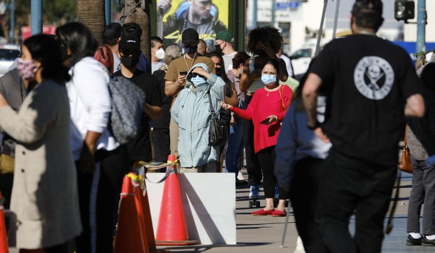People wait in line to be tested for COVID-19 at a testing site in the North Hollywood section of Los Angeles on Saturday, Dec. 5, 2020. With coronavirus cases surging at a record pace, California Gov. Gavin Newsom announced a new stay-at-home order and said if people don&#39;t comply the state&#39;s hospitals will be overwhelmed with infected patients.(AP Photo/Richard Vogel)