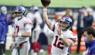 New York Giants quarterback Colt McCoy passes as he warms up before an NFL football game against the New York Giants, Sunday, Dec. 6, 2020, in Seattle. (AP Photo/Elaine Thompson)