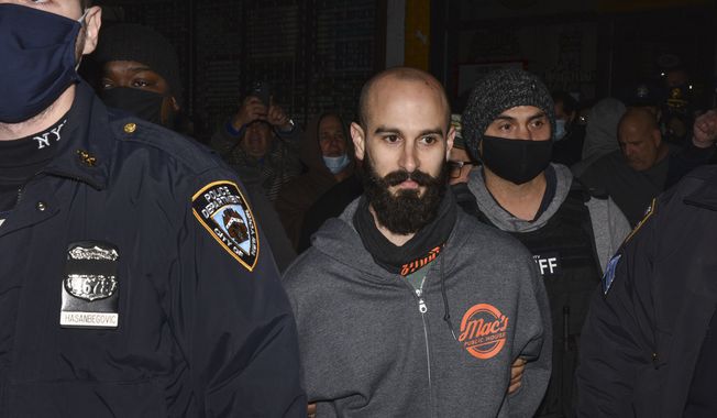 Mac&#x27;s Public House co-owner Danny Presti is taken away in handcuffs after being arrested by New York City sheriff&#x27;s deputies, Tuesday, Dec. 1, 2020, in the Staten Island borough of New York. Presti, who authorities said has been defying coronavirus restrictions, was taken into custody early Sunday, Dec. 6, 2020 after running over a deputy with a car, authorities said. Presti tried to drive away from his bar, Mac&#x27;s Public House, as deputies were arresting him for serving patrons in violation of city and state closure orders, Sheriff Joseph Fucito said. (Steve White via AP)