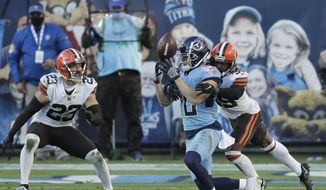 Tennessee Titans wide receiver Adam Humphries (10) loses control of the ball as he is hit by Cleveland Browns cornerback Terrance Mitchell (39) in the second half of an NFL football game Sunday, Dec. 6, 2020, in Nashville, Tenn. The Browns intercepted the ball on the play. (AP Photo/Ben Margot) **FILE**