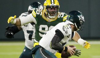 Green Bay Packers&#39; Kingsley Keke sacks Philadelphia Eagles&#39; Carson Wentz during the first half of an NFL football game Sunday, Dec. 6, 2020, in Green Bay, Wis. (AP Photo/Mike Roemer)