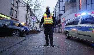 A policeman at the scene after a bomb was found in a a residential area in the Gallus district of Frankfurt, Germany, Sunday, Dec. 6, 2020. German explosives experts have successfully defused and disposed of a 500 kilogram (1,100 pound) bomb in the country’s financial capital Frankfurt, which was dropped during World War II and discovered during recent construction. Some 13,000 residents were evacuated from the city’s Gallus district Sunday and trains were stopped from running through the area as Hesse state experts went to work on the bomb. (Frank Rumpenhorst/dpa via AP)
