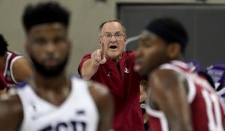 Oklahoma head coach Lon Kruger, center, instructs his team in the second half of an NCAA college basketball game against TCU in Fort Worth, Texas, Sunday, Dec. 6, 2020. (AP Photo/Tony Gutierrez) **FILE**