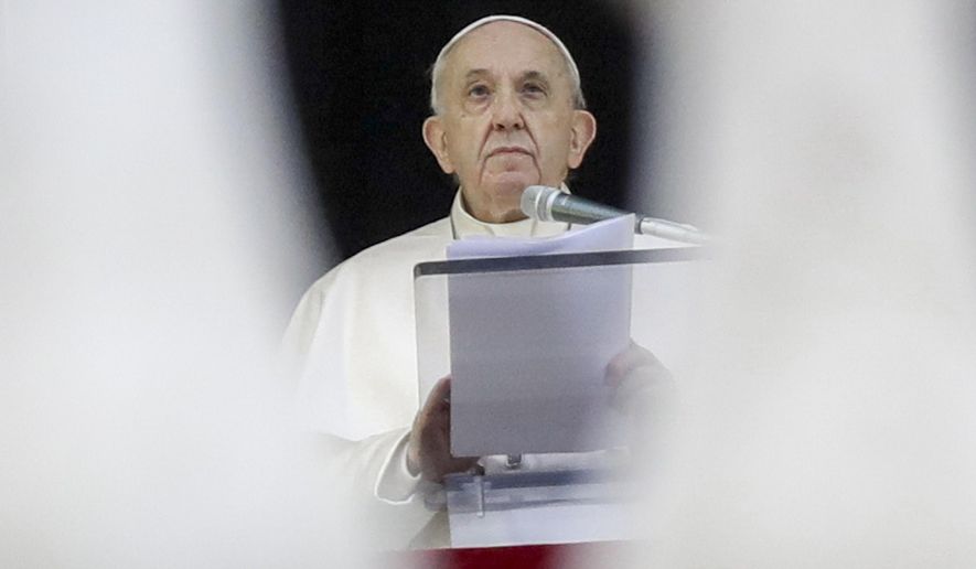 Pope Francis recites the Angelus noon prayer from the window of his studio overlooking St.Peter's Square, at the Vatican, Sunday, Dec. 6, 2020. (AP Photo/Andrew Medichini)